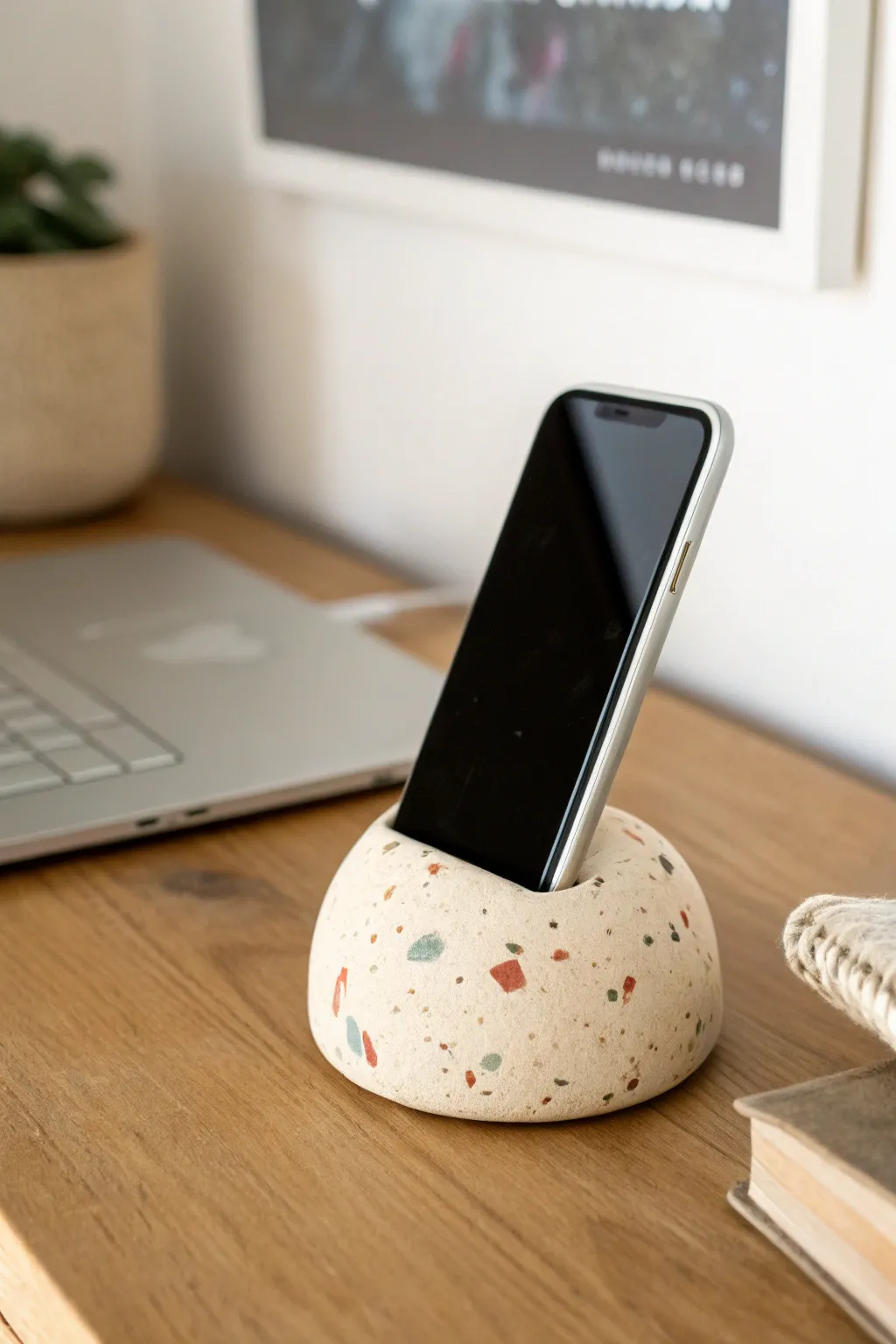 Chunky terrazzo clay phone stand with soft speckles, a minimalist desk accent with cozy charm
