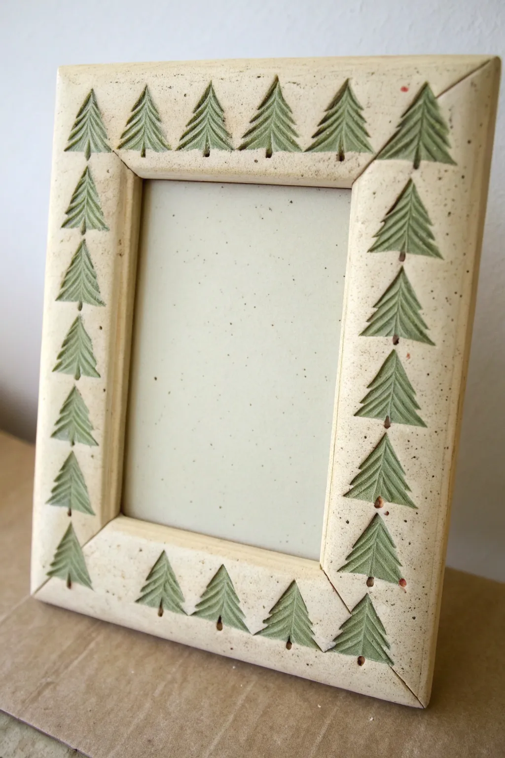 Evergreen silhouette clay frame with muted forest greens, minimalist Nordic charm and boho warmth