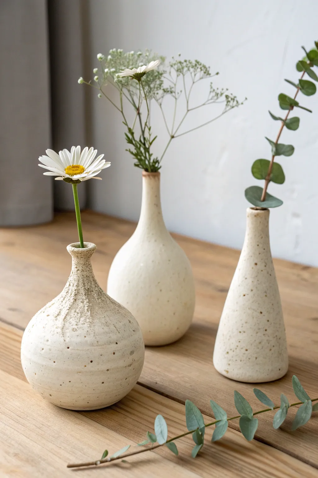 Three tiny bud vases, three simple shapes, each making a single stem look special.