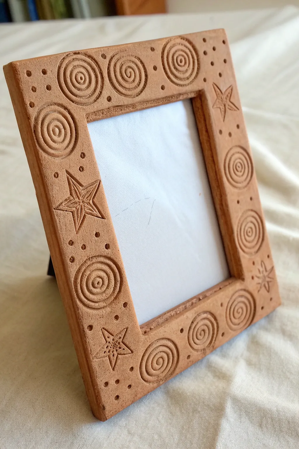 Textured coil clay picture frame with a cute star detail, minimalist and easy for middle school.