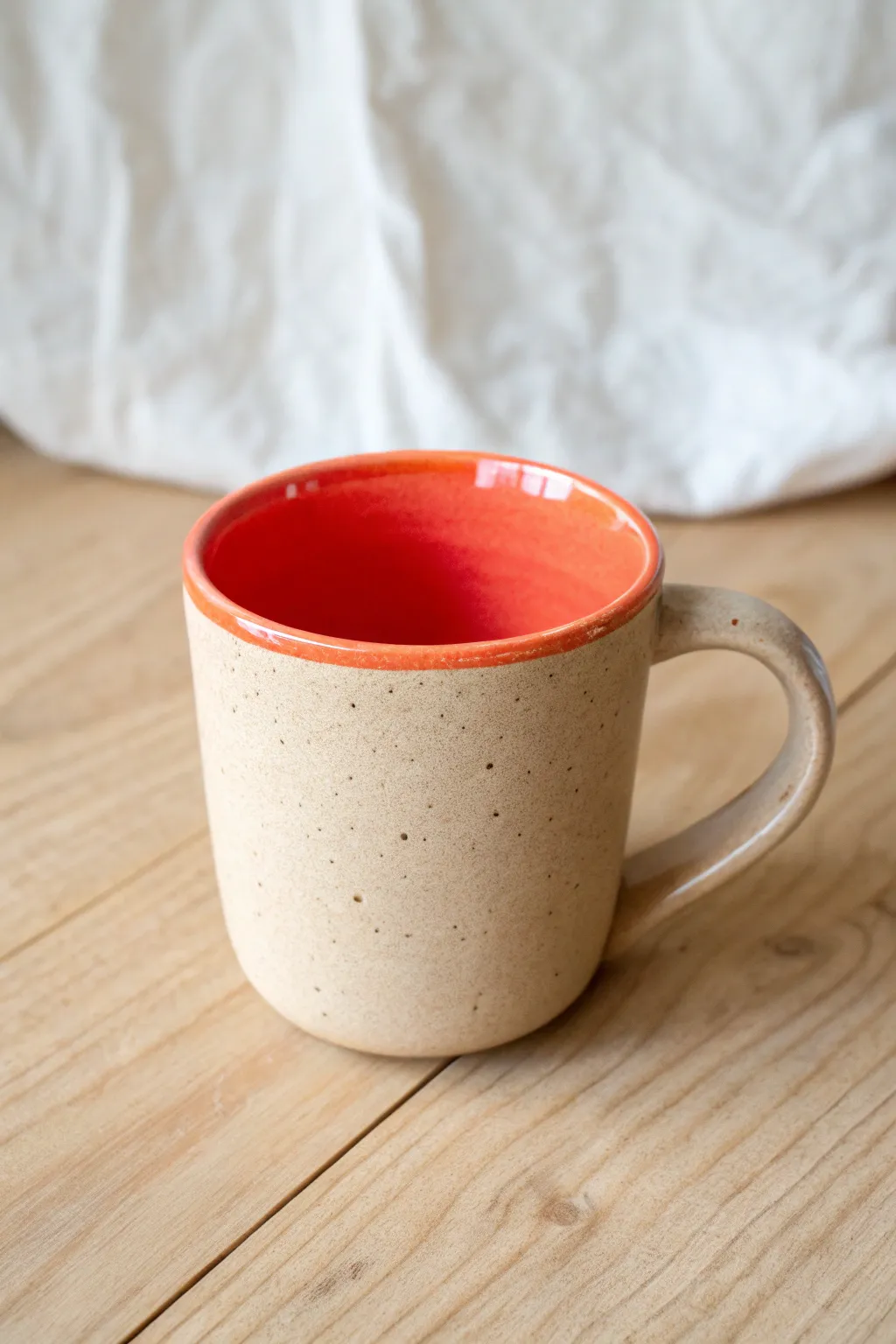 Neutral outside, vibrant inside: a simple mug design that delights with every morning sip