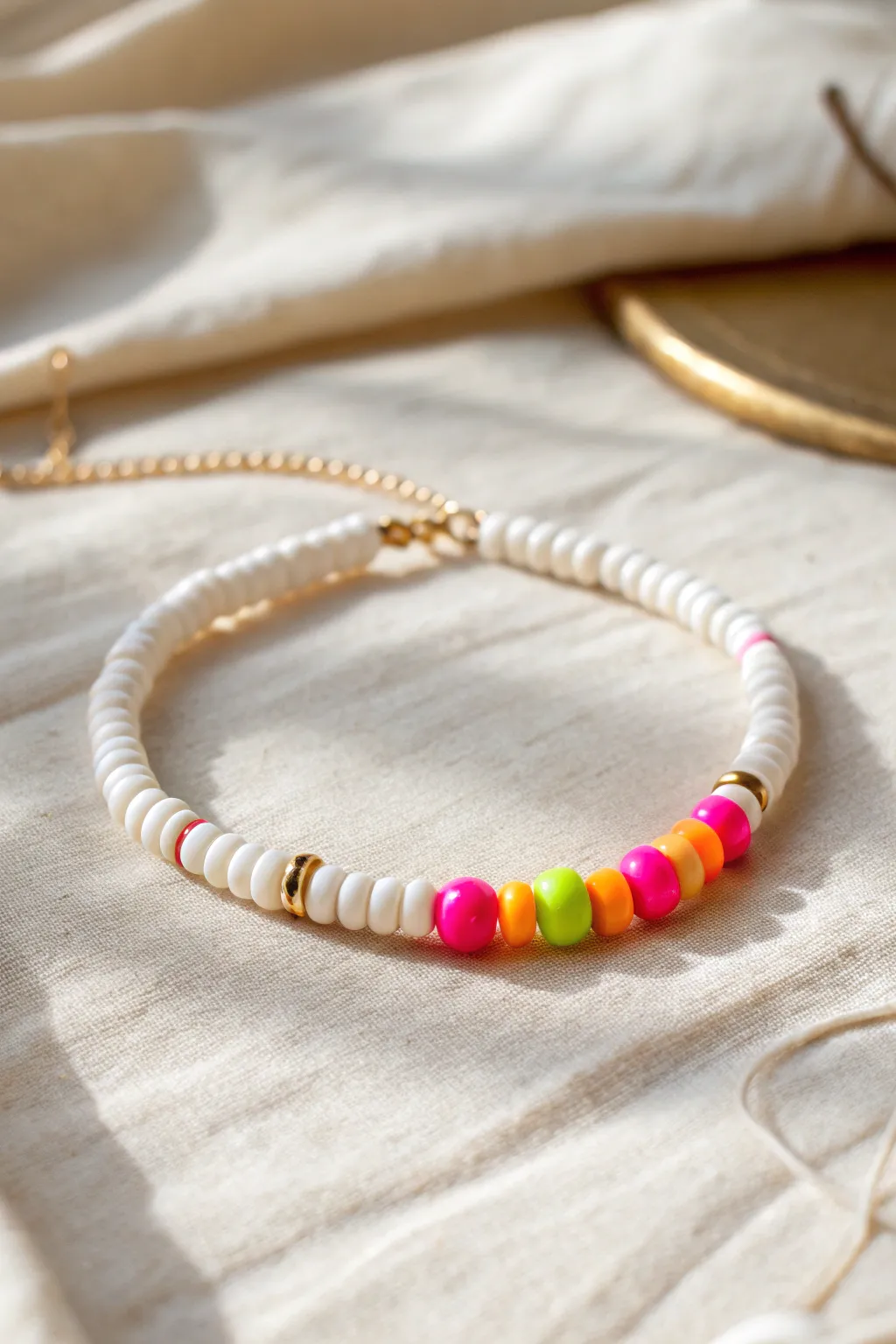 All-white heishi bracelet with one neon pop-bead section for a clean, minimalist vibe.