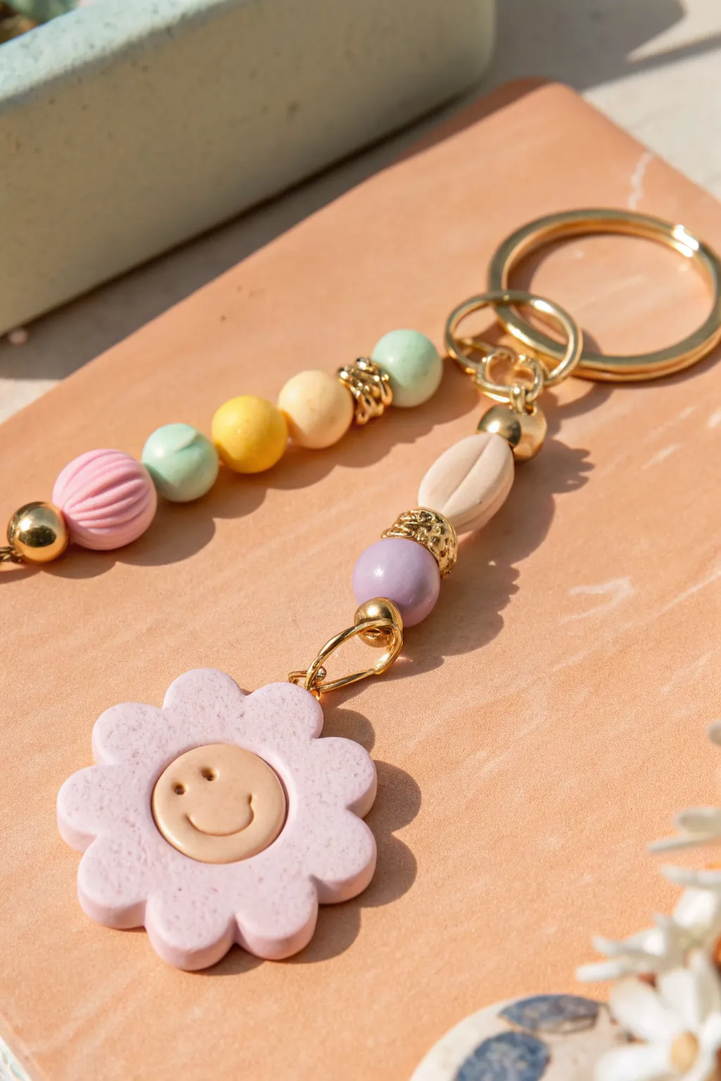 Smiley flower focal bead keychain with pastel heishi beads for a cute, minimal boho vibe.
