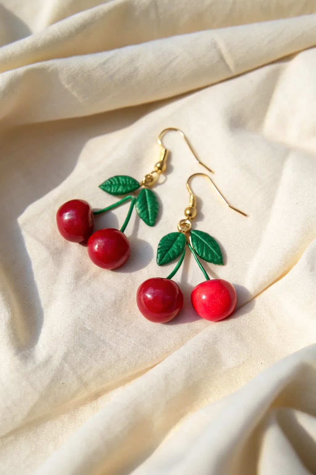 Glossy cherry clay dangles with tiny leaf tops, the sweetest pop of red for everyday wear.