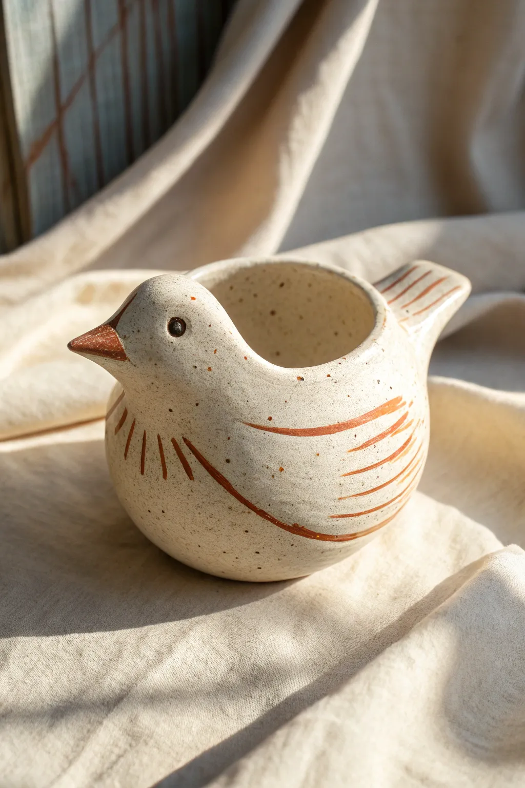 Make a sweet little bird pinch pot with a beak rim and simple painted wings in minutes