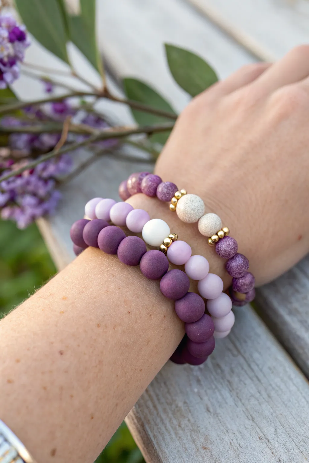 Cute purple clay bead bracelet stack with ombre, gold spacers, and crisp white accents