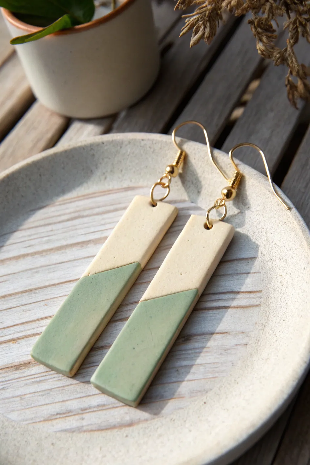 Minimal two-tone clay bar earrings in sage and cream, clean seam, soft Scandinavian styling.