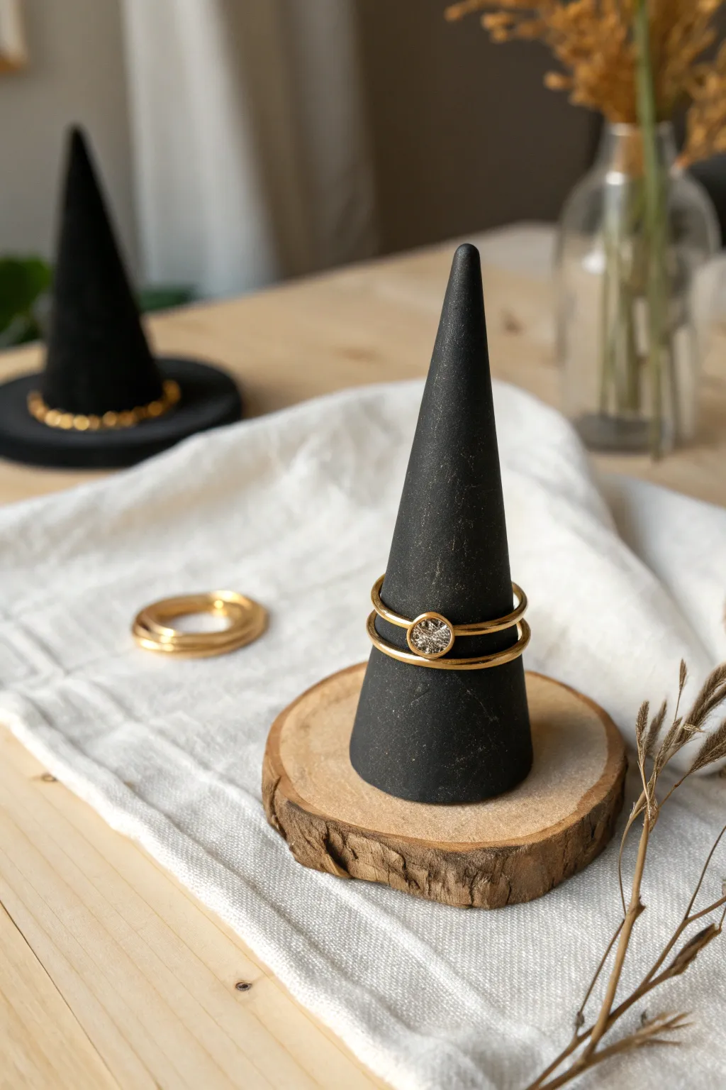 Minimal black clay witch hat ring cone with gold rings, a chic DIY Halloween decor accent