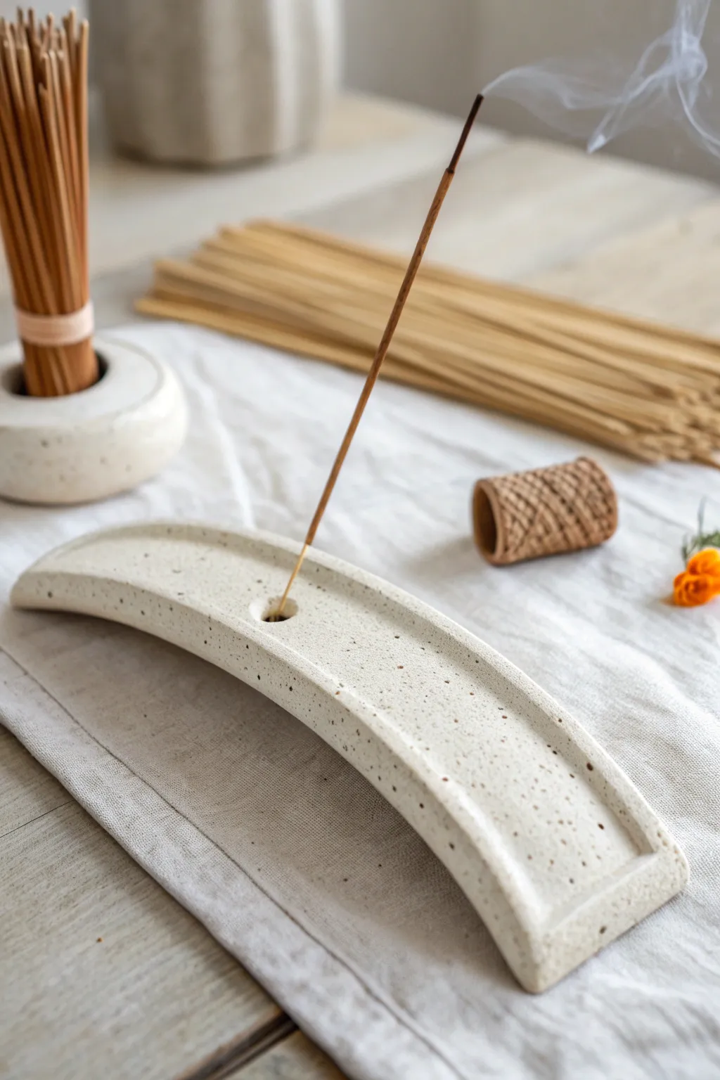 Minimal air dry clay incense holder with soft curve and hand-textured finish in calm neutrals.