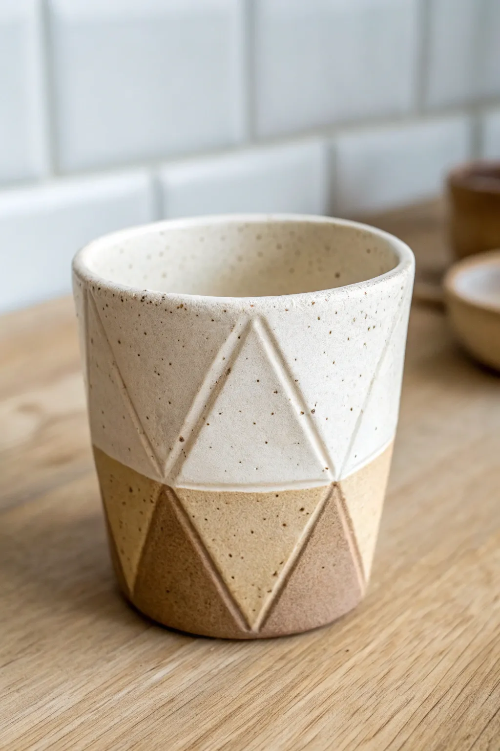 Faceted slab cup in soft two-tone glaze, minimalist lines that make everyday sips feel special.