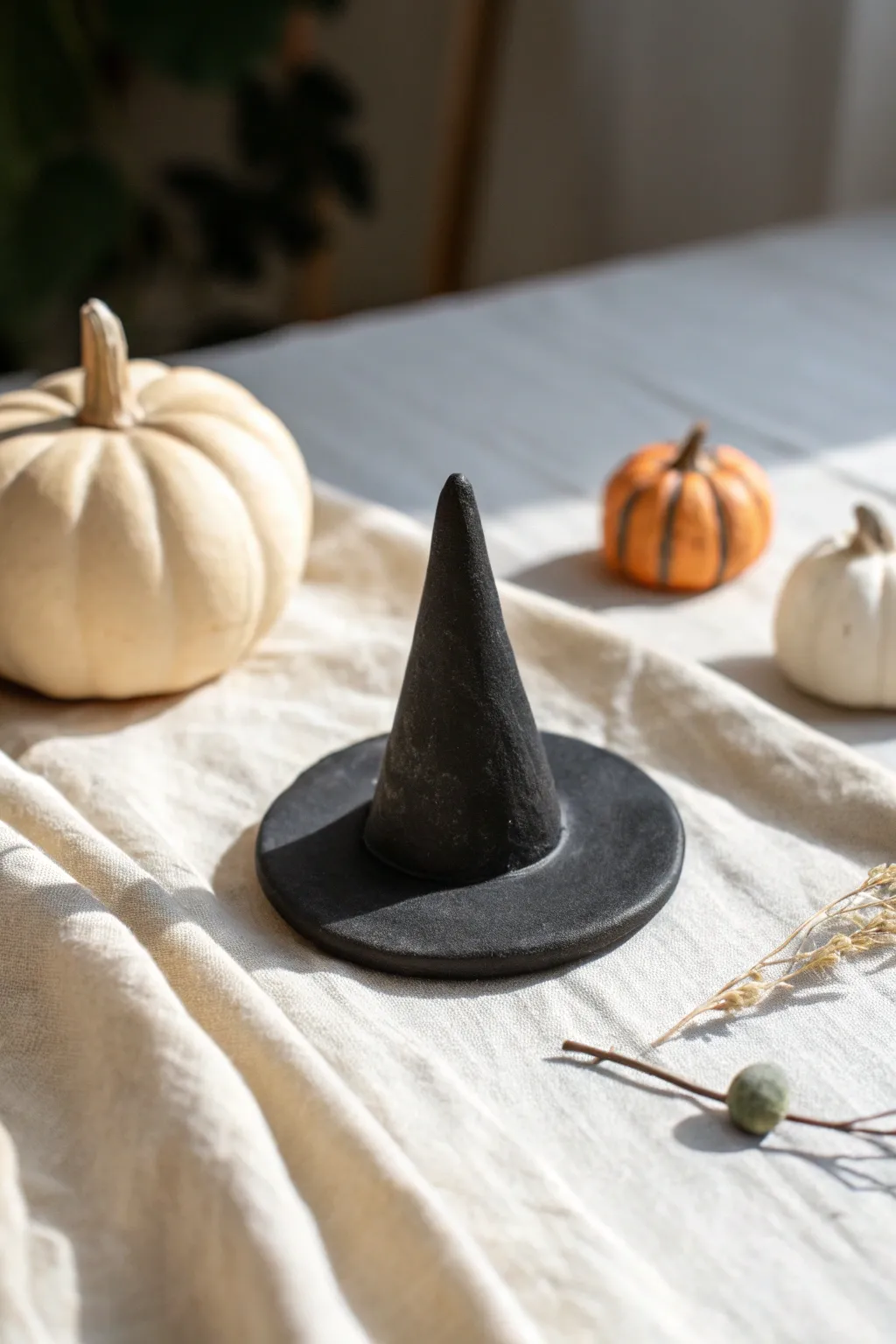 Tiny matte black witch hat topper in minimalist styling, perfect for easy Halloween clay figures