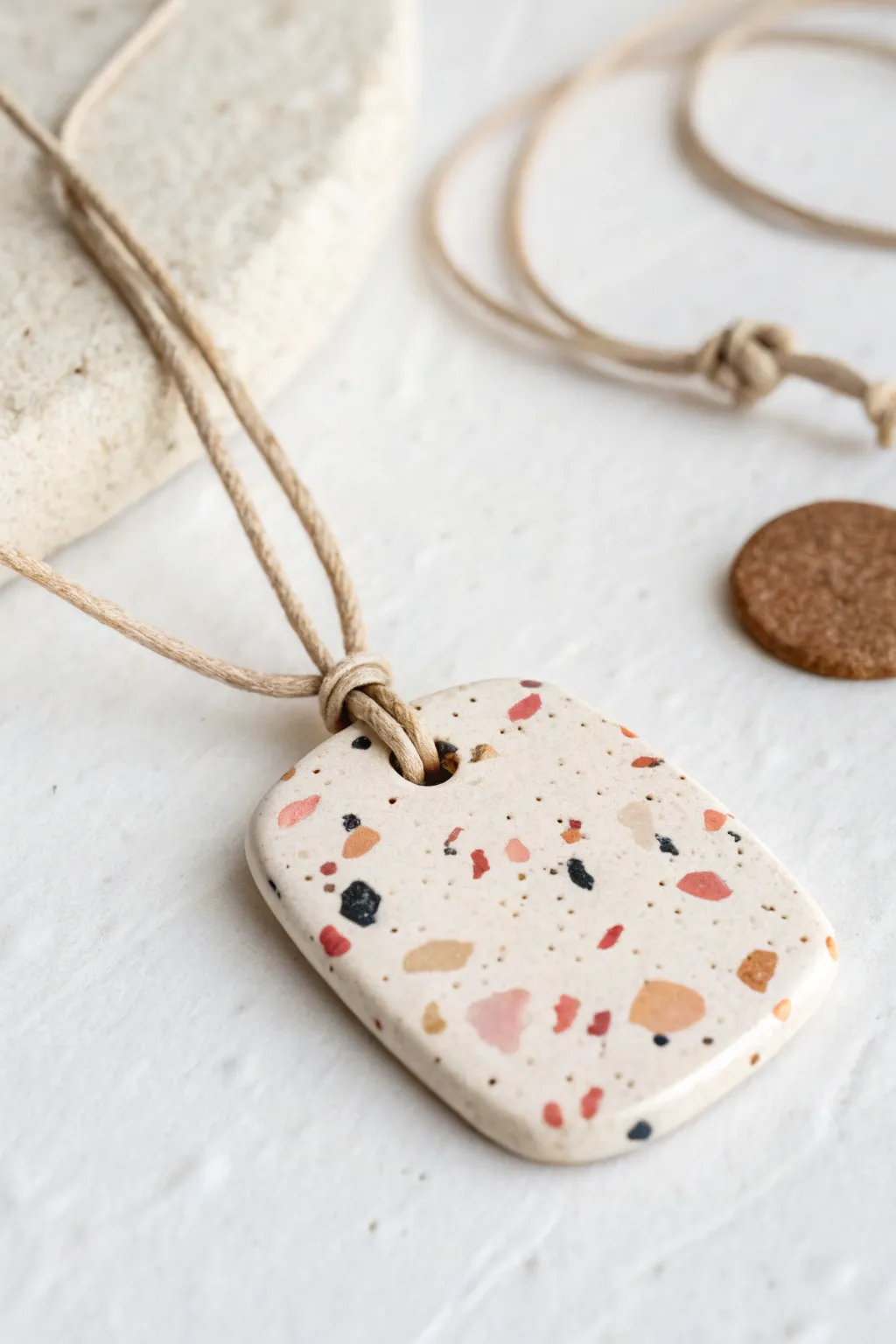 Speckled confetti polymer clay pendant on a simple cord, minimal, modern, and easy to make.