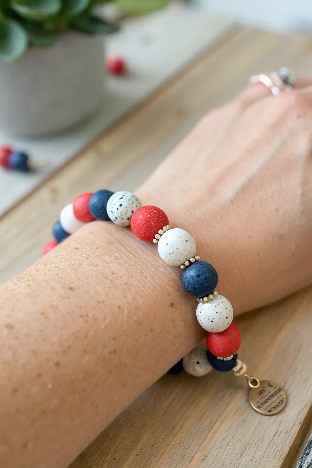 Confetti-style red, white, and blue clay bead bracelet for a soft boho Fourth of July look.