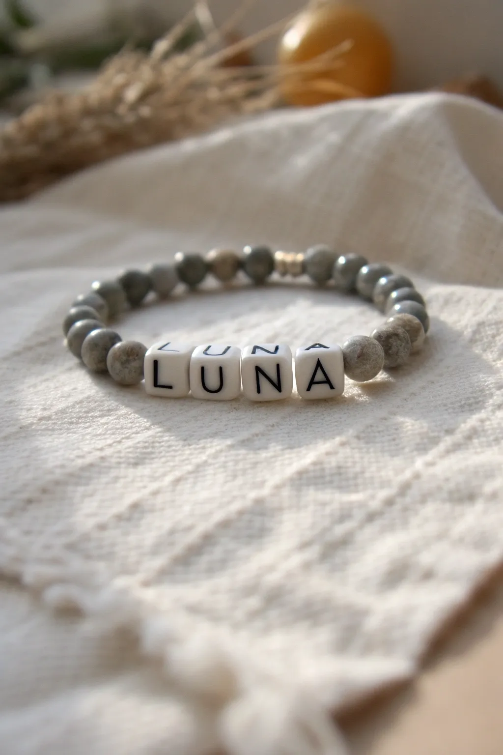 Grey clay beads frame centered letter beads for a minimalist Scandinavian boho bracelet idea