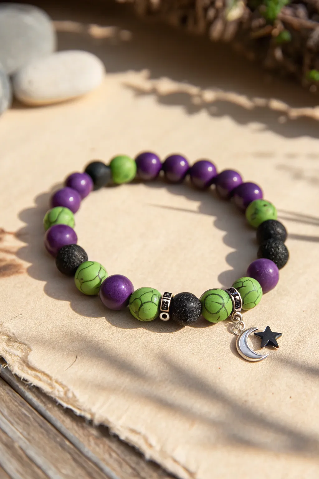 Witchy clay bracelet in purple, slime green, and black with a simple crescent moon accent