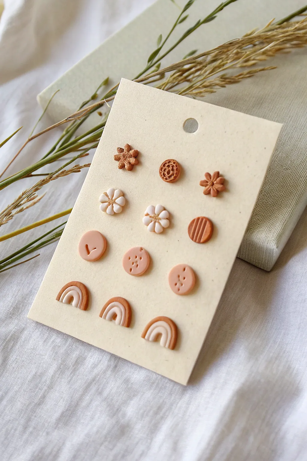 Tiny clay stud earring pairs in soft neutrals, simple shapes, perfect for quick mini projects.