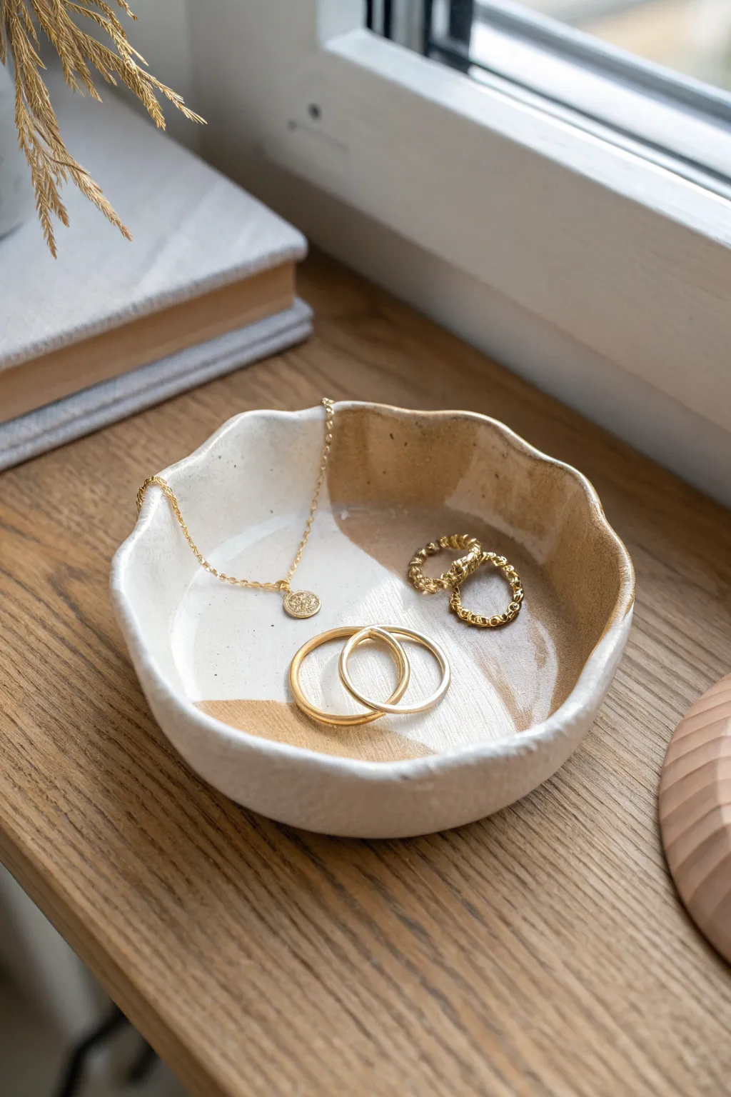 Wavy-lip clay catchall dish with a calm two-tone finish, perfect for storing daily jewelry.