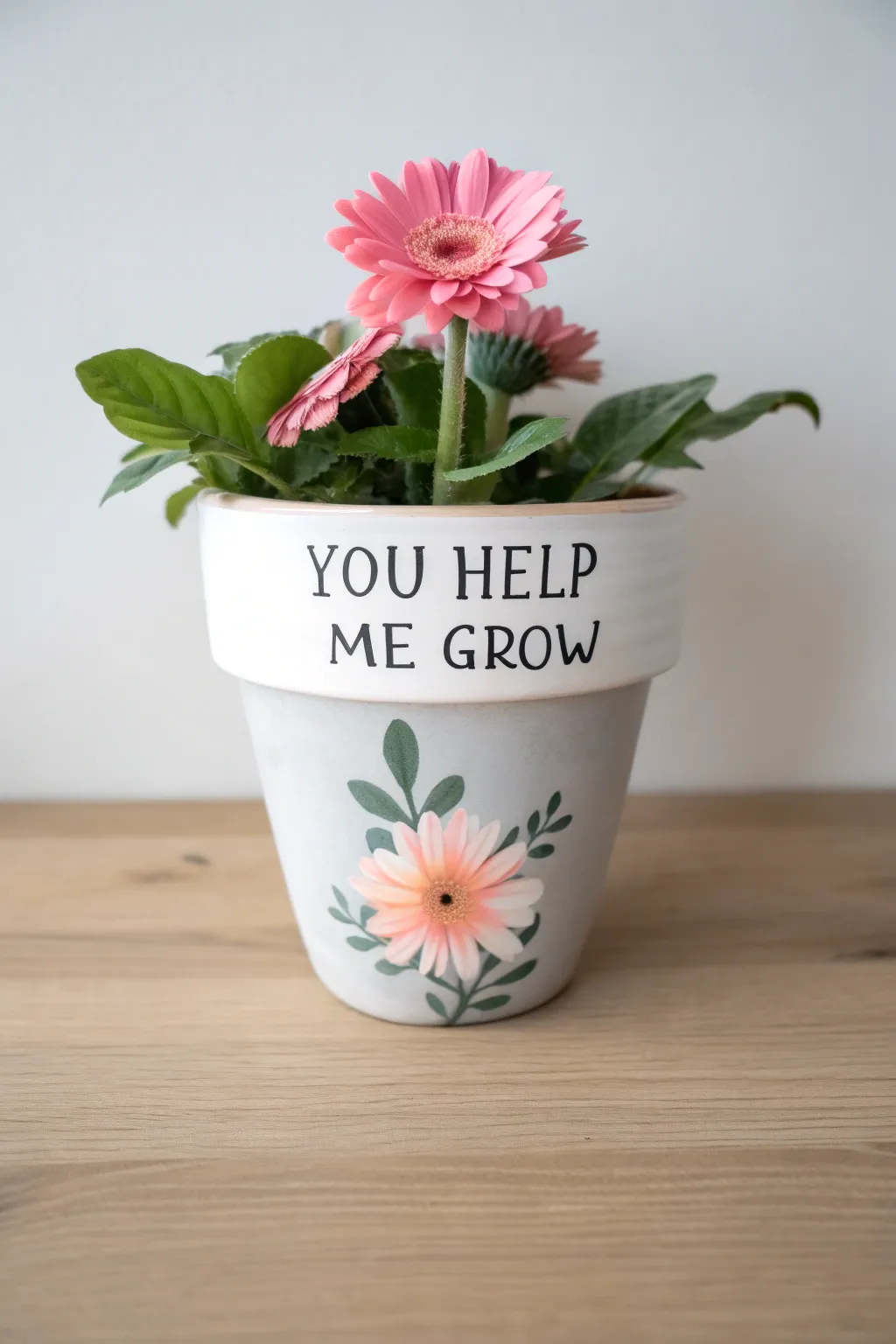 A sweet Mothers Day message pot with You Help Me Grow lettering and one bright bloom, gift-ready.