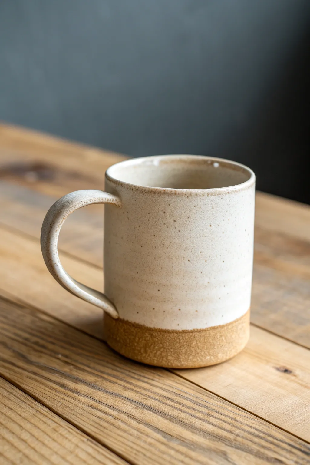 Pinched cylinder mug with a slab base, modern and minimal yet warmly handmade in natural clay.