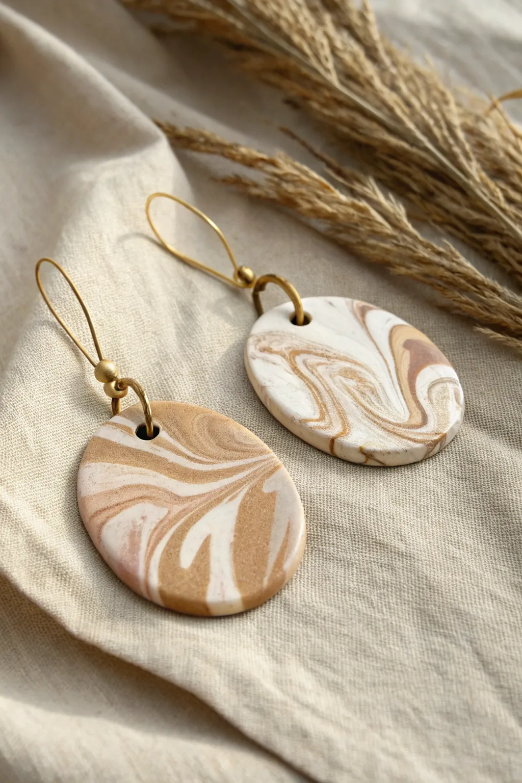 Muted marbled polymer clay pendants on linen, minimalist and boho for easy DIY jewelry inspiration.