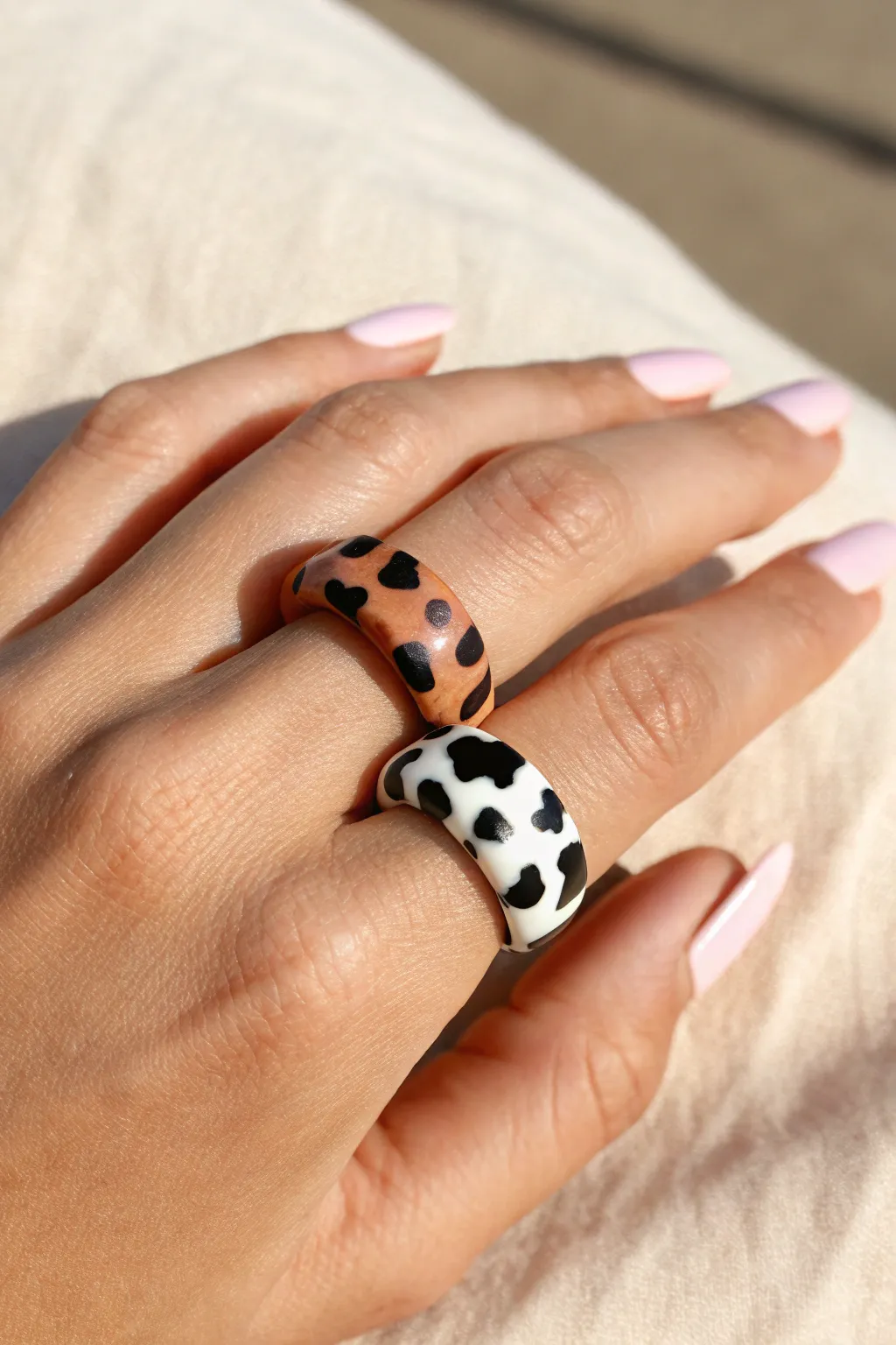 Cow print pop rings in chic colorways for a playful, handmade statement stack.