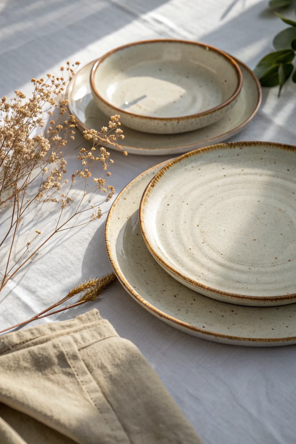 Slab-built dinner plates with pressed texture, softly stacked for a minimal boho table look