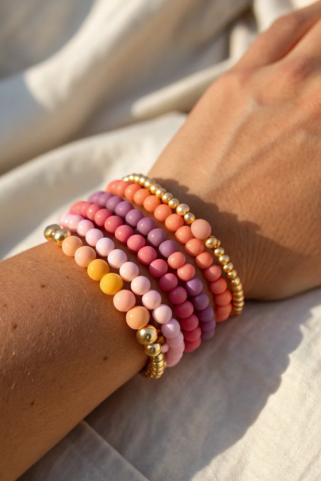 Sunset ombre clay bead bracelet stack in warm light, preppy-cute and effortlessly minimal.