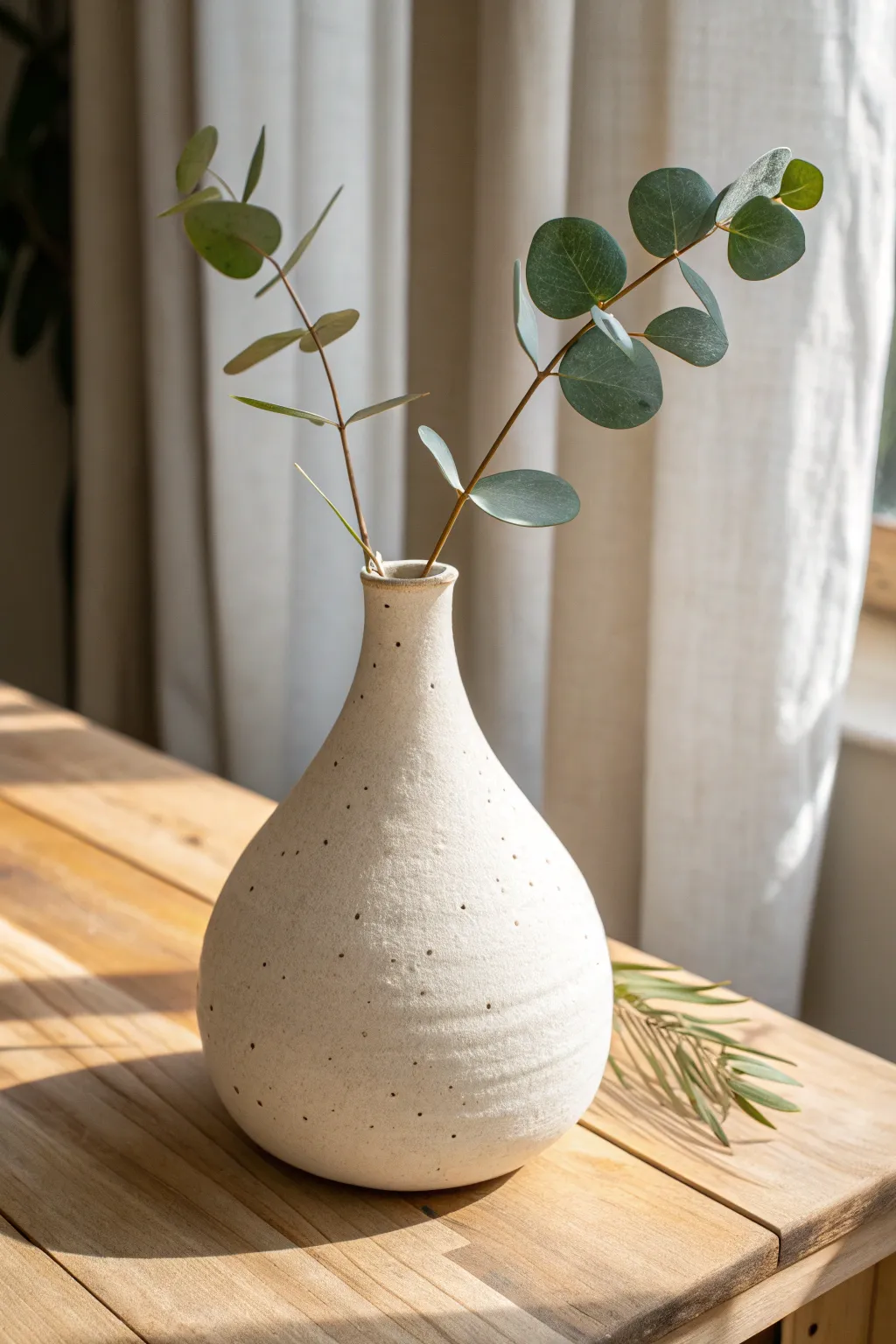 Tapered slab vase with a narrow neck, styled simply with one stem for calm contrast.