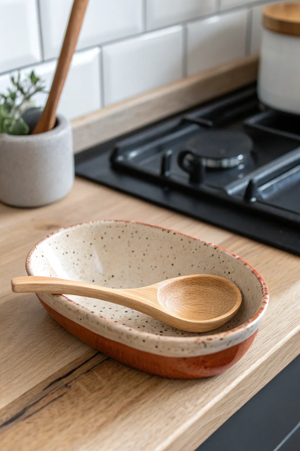 Speckled ceramic spoon rest that keeps countertops clean, simple, handmade, and beautifully minimal.