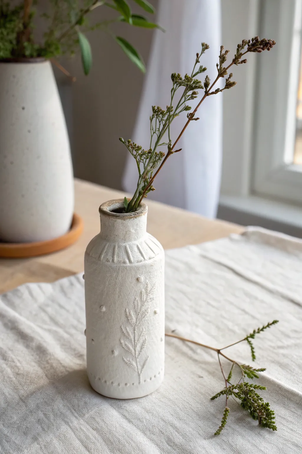 Beginner-friendly mini air dry clay sleeve bud vase, minimalist and softly styled in natural light.