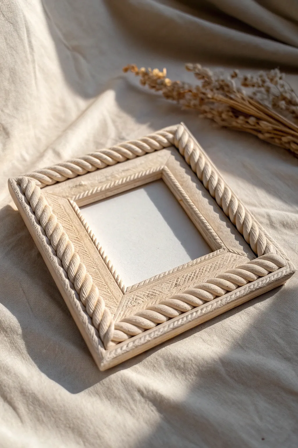 Square air dry clay frame with a sandy rope-twist rim, softly lit to highlight texture