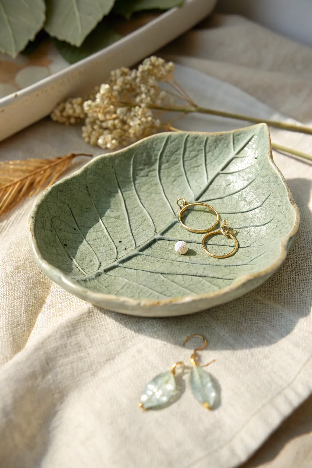 Sage green leaf-imprint clay dish with delicate veins, perfect for tiny treasures and studs