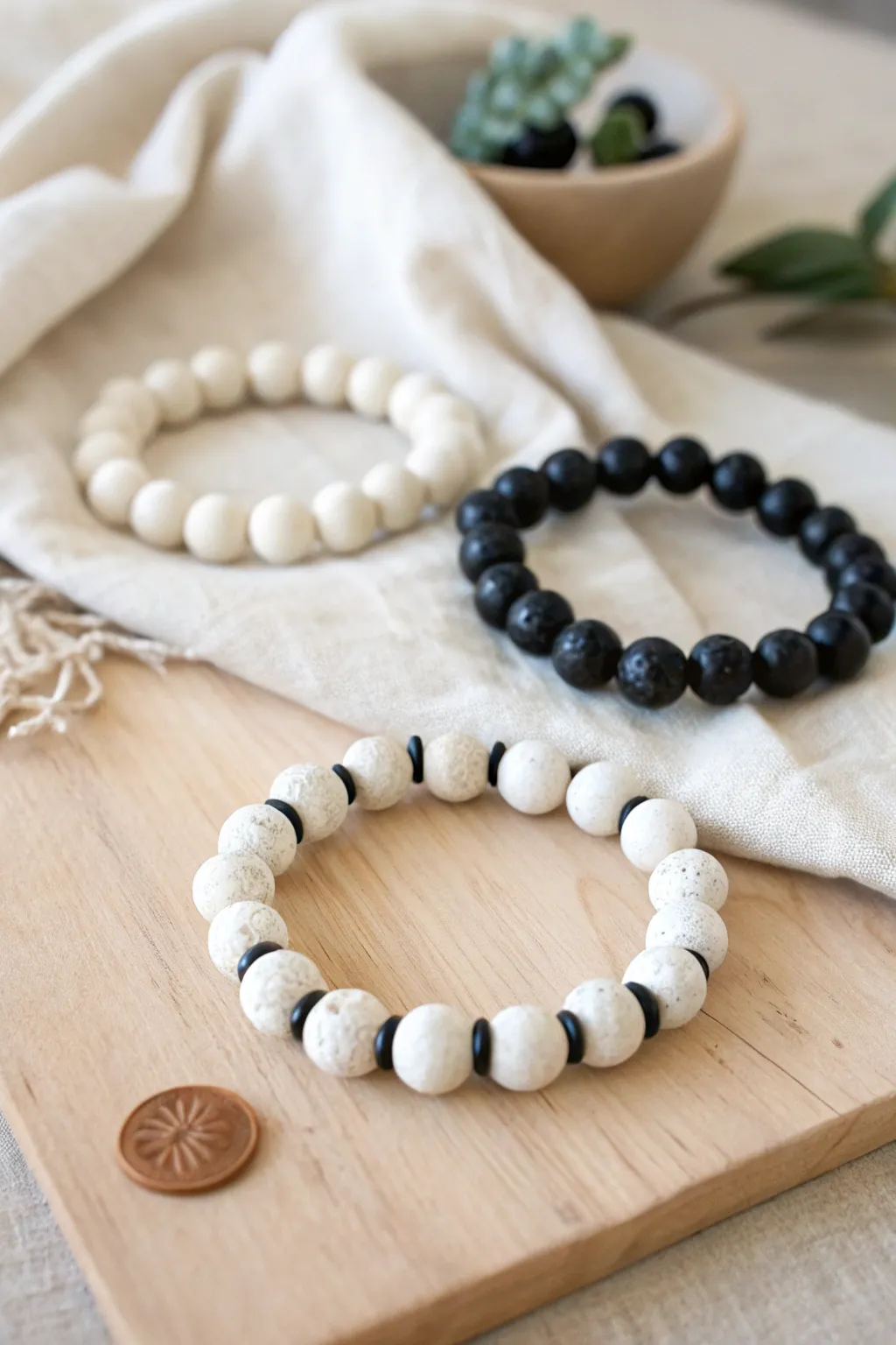 Mostly white clay beads with a bold black pop, styled for effortless minimalist stacking.