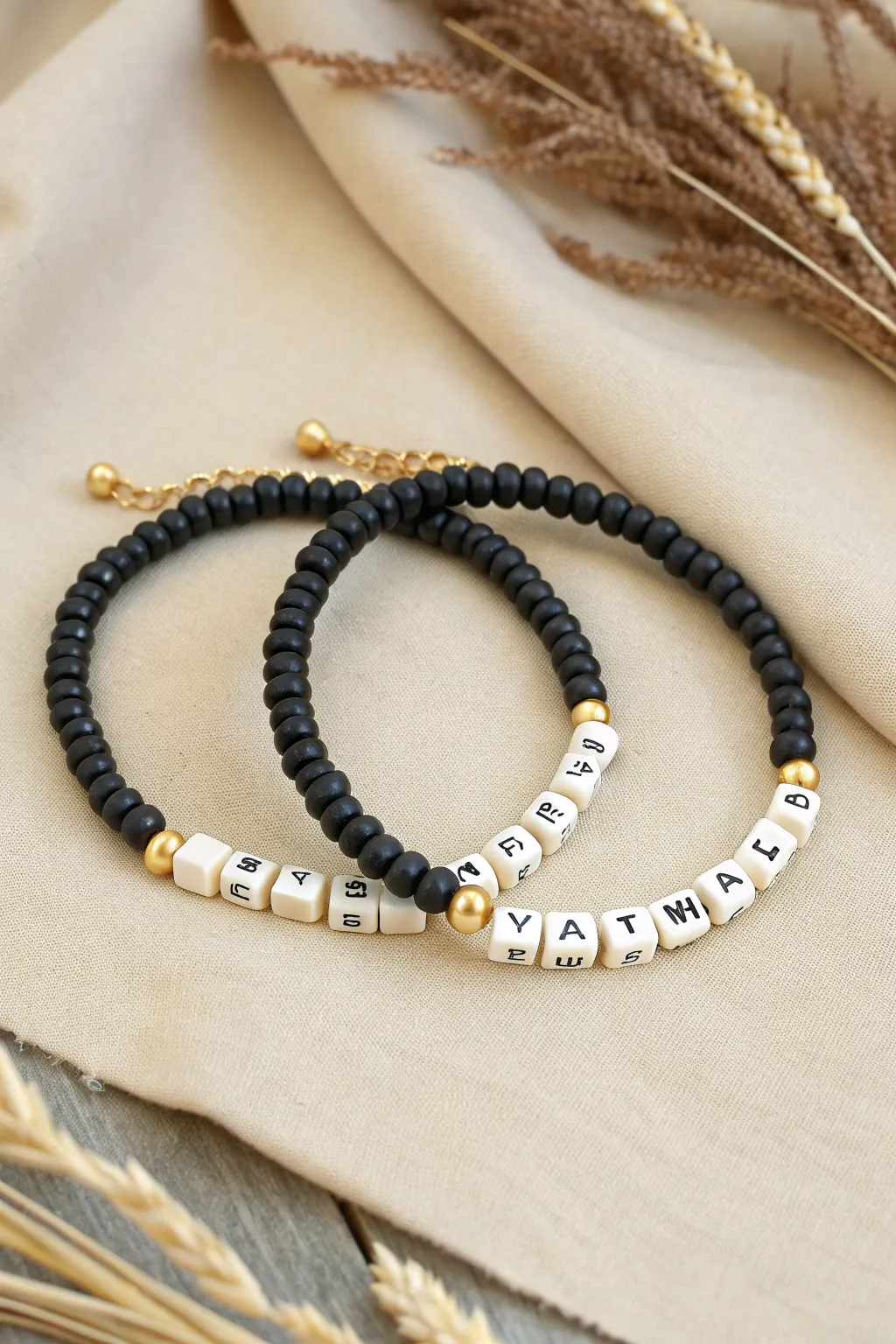 Minimal black heishi friendship bracelets with white cube accents, a chic DIY gift set.