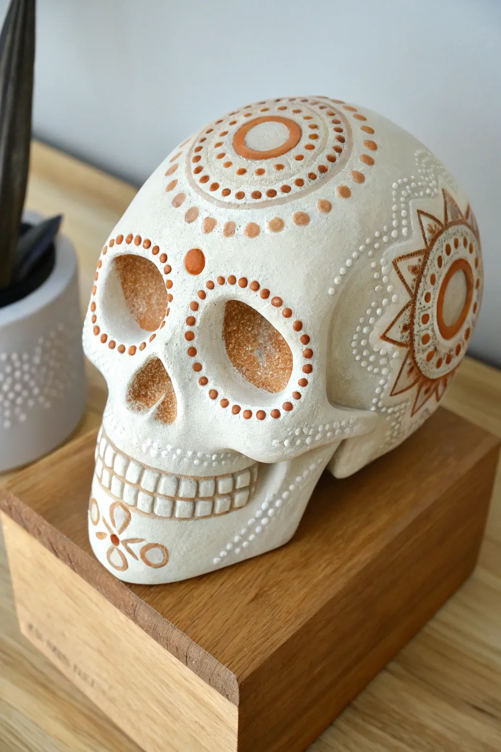 Minimal sugar skull with mandala dot eyes, warm neutrals and soft light for calm boho vibes