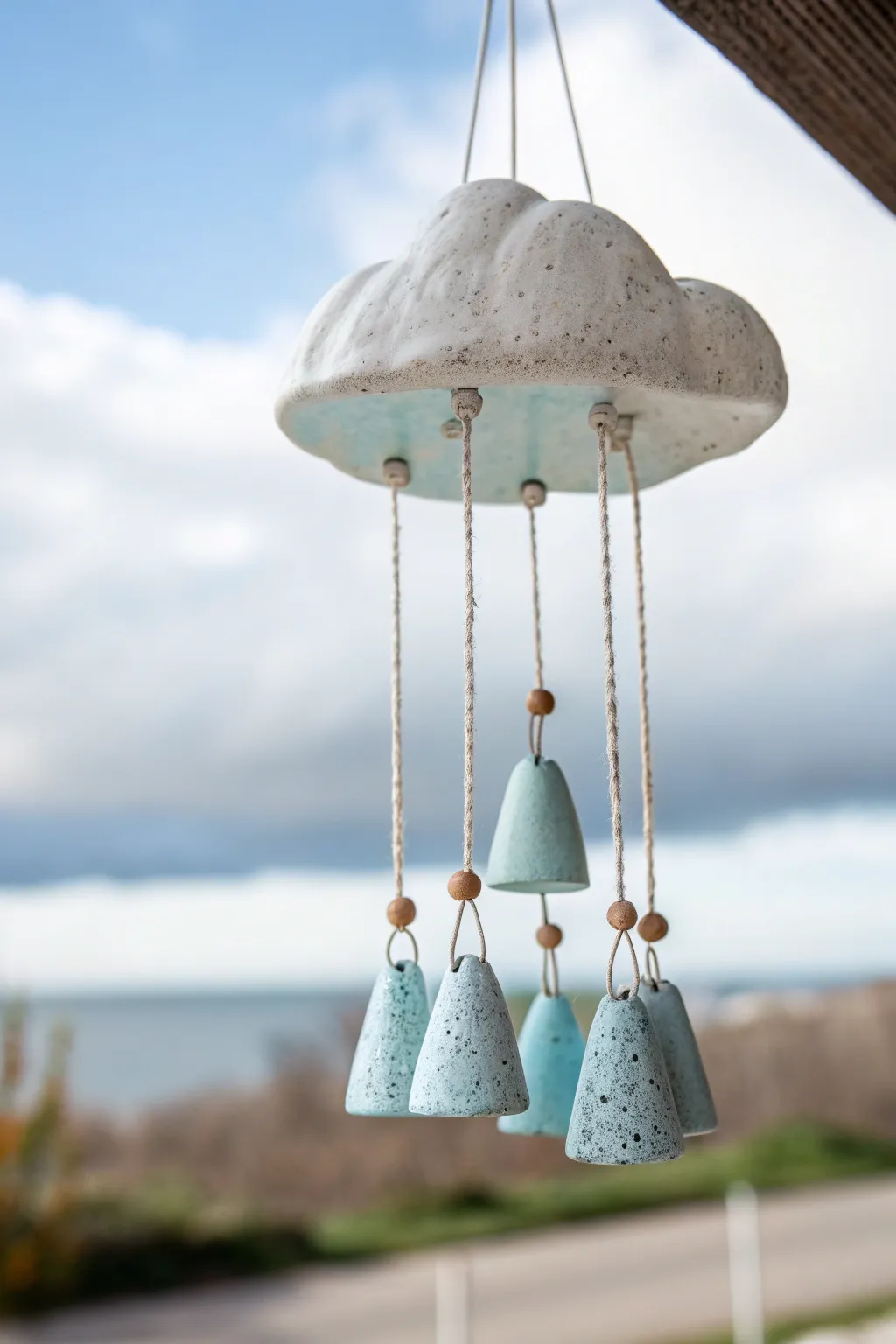 Minimal cloud and raindrop ceramic wind chime in soft blues, perfect for a calm airy space