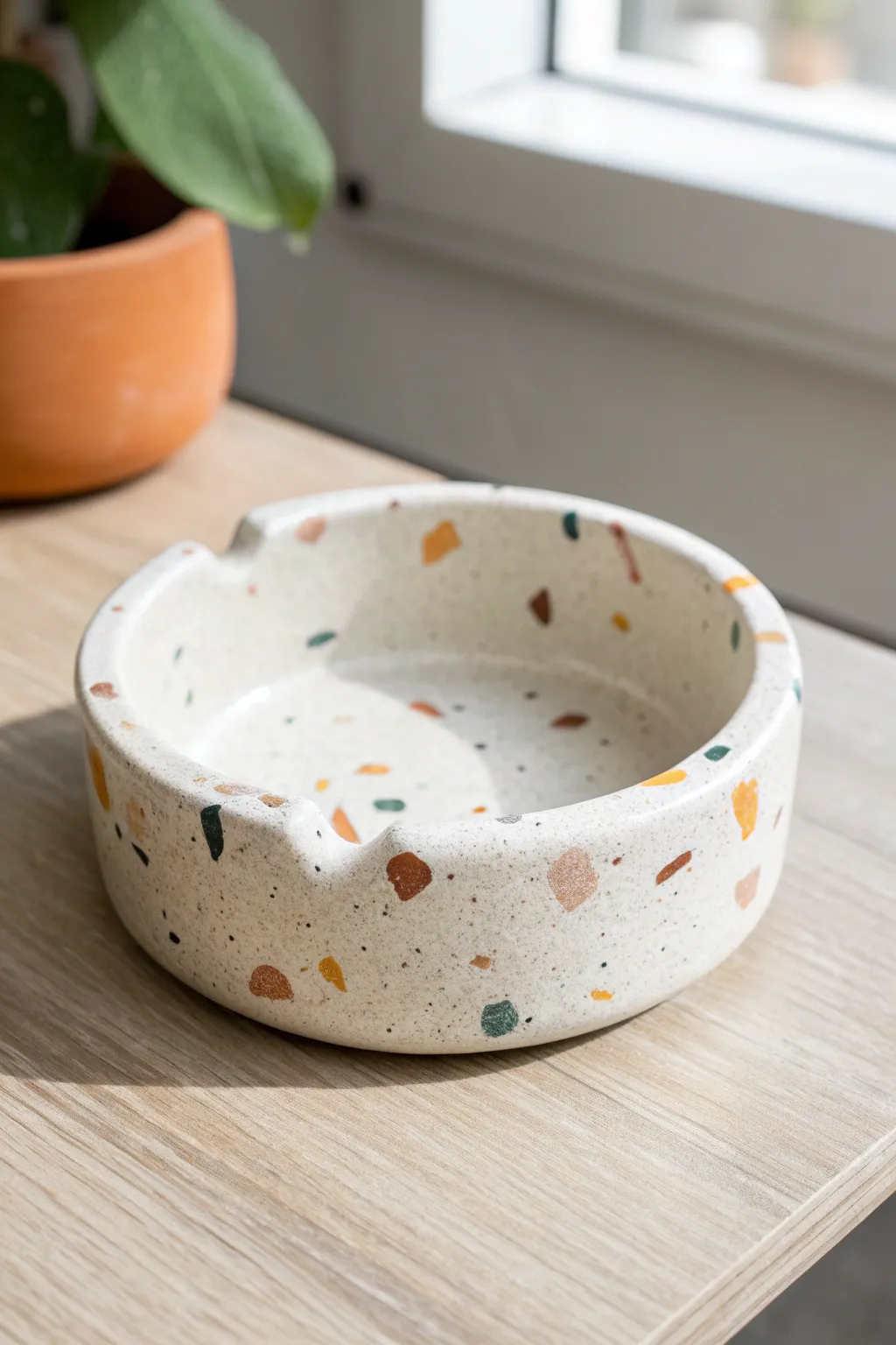 Glossy terrazzo-speckled clay ashtray in soft earthy tones for a chic minimalist moment