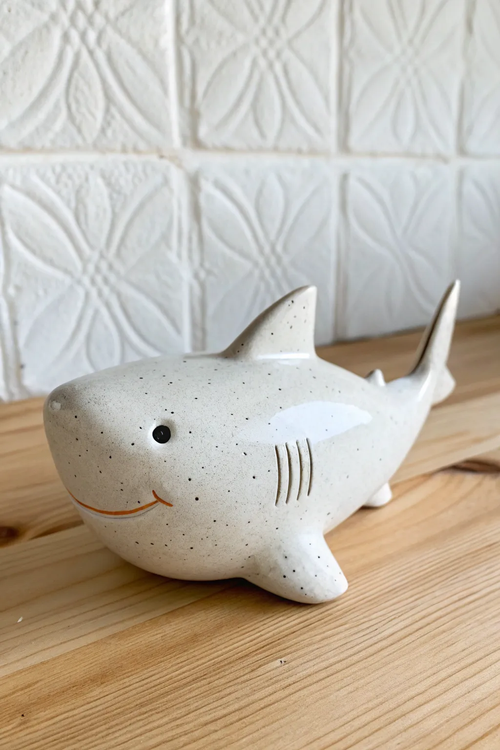 Minimalist shark coin bank with sleek dorsal fin and back slot, perfect for a cute savings nook.