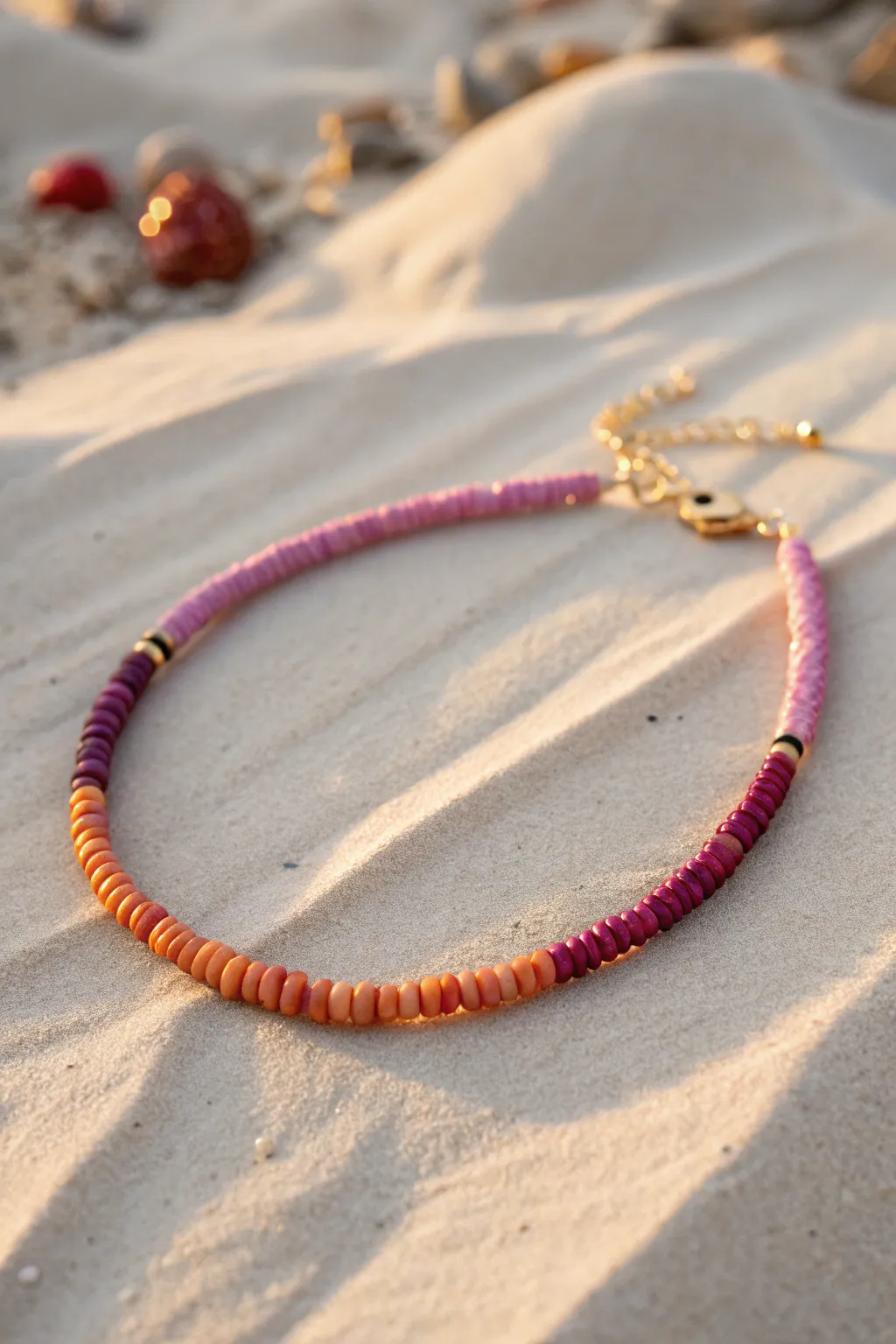 Sunset ombre heishi clay bead anklet in golden-hour light, coral to purple perfection.