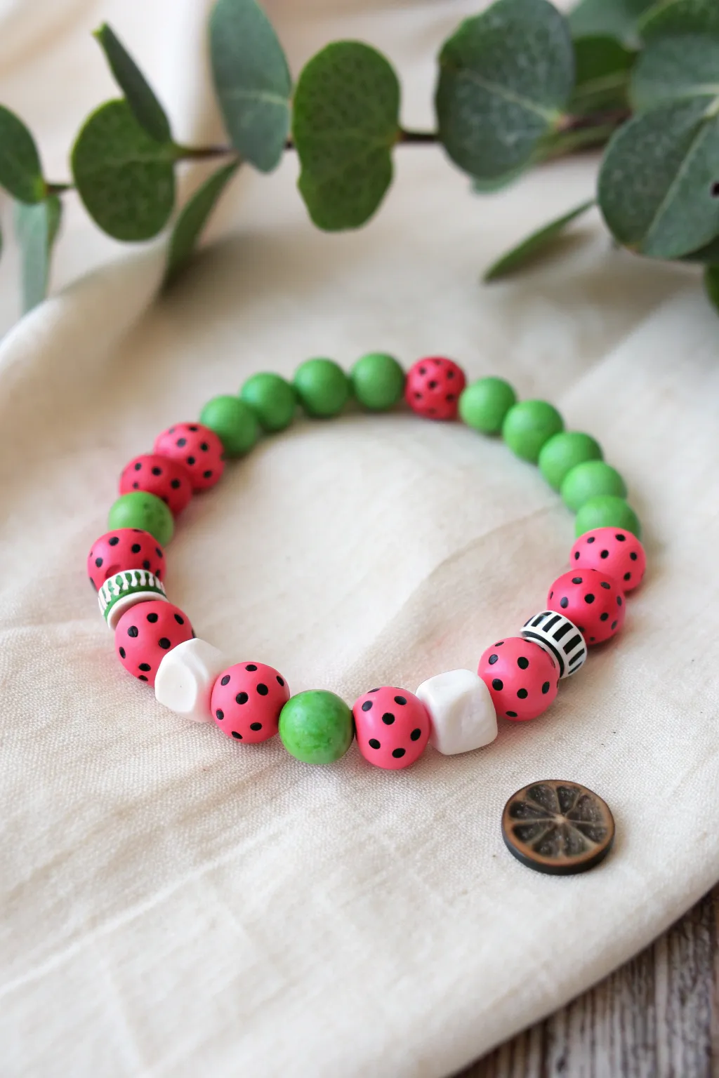Watermelon Pop clay bead bracelet: pink, green and white with tiny black seed accents.