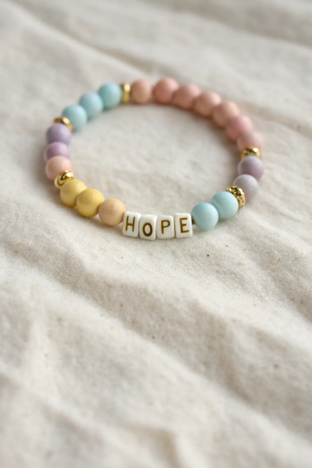 Pastel clay bead bracelet with HOPE centerpiece, minimalist boho vibe for bright optimism