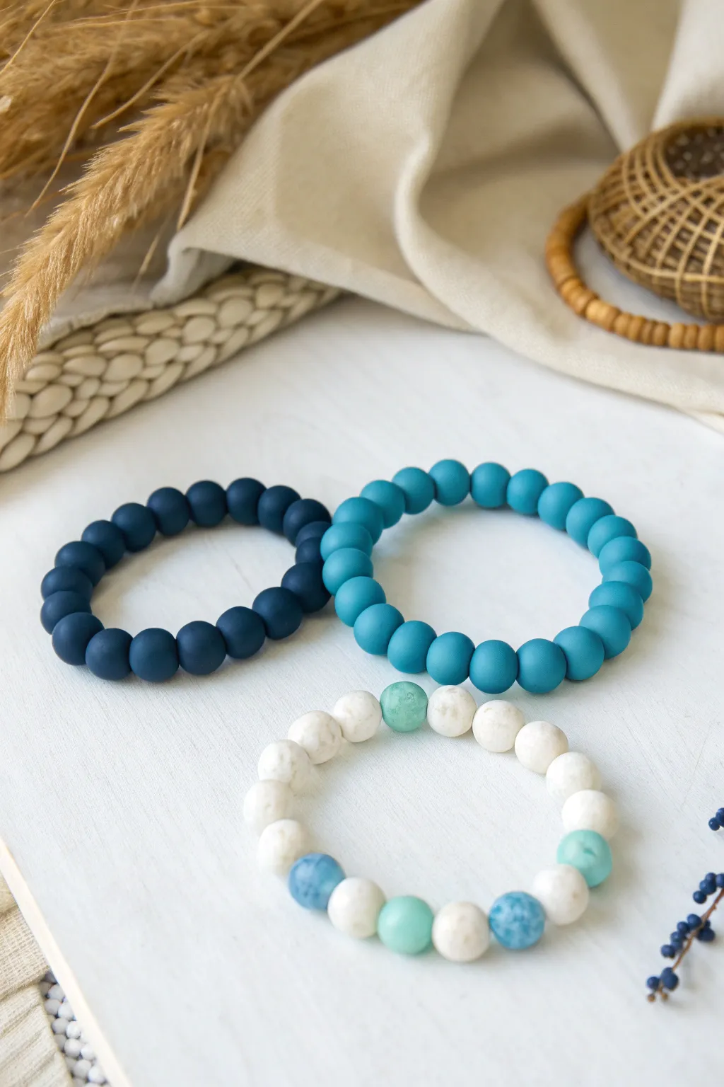 Ocean-inspired clay bead bracelet color combos in navy, turquoise, sky blue, and seafoam