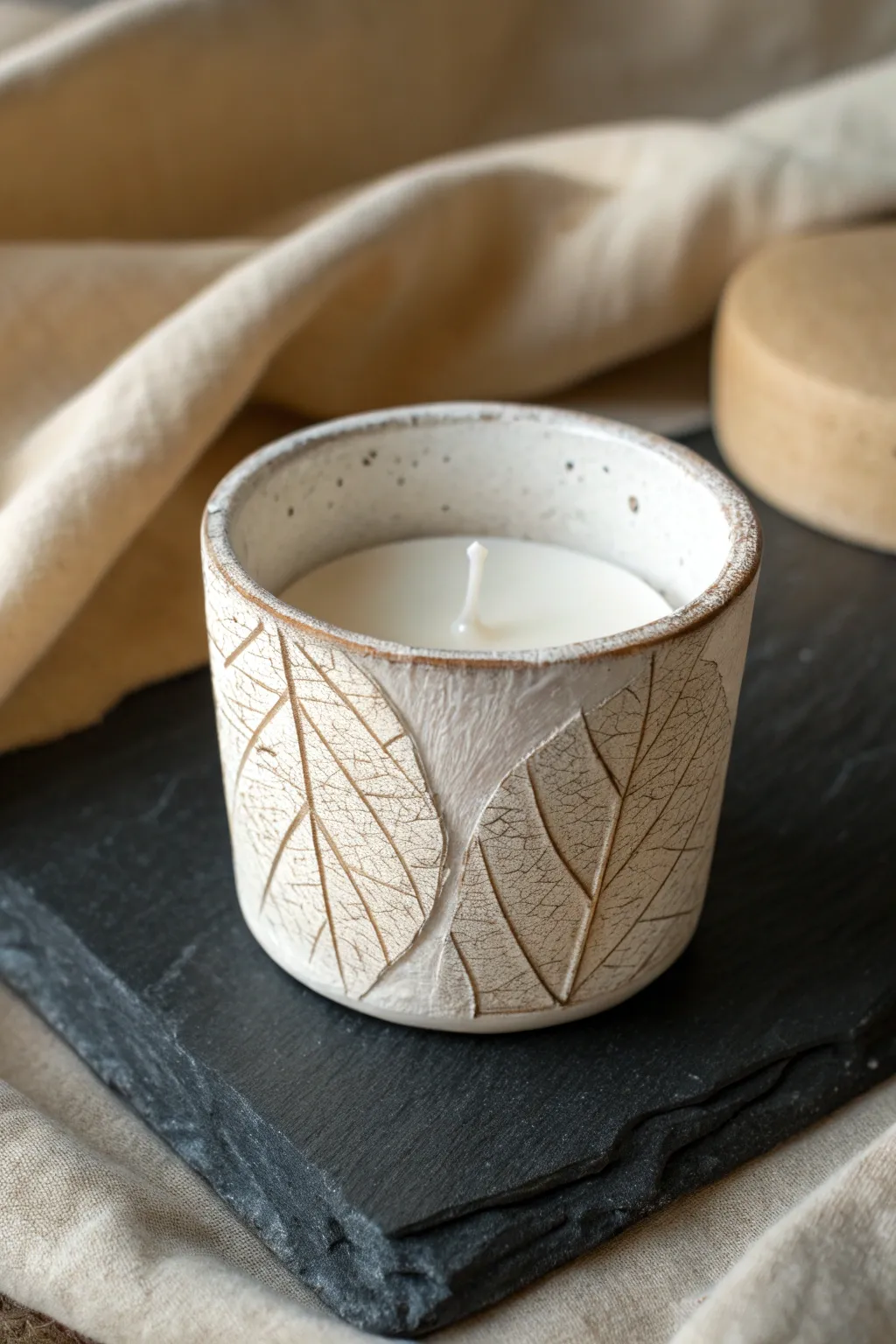 Leaf-imprint tea light cup with matte clay and crisp botanical texture for calm Nordic warmth