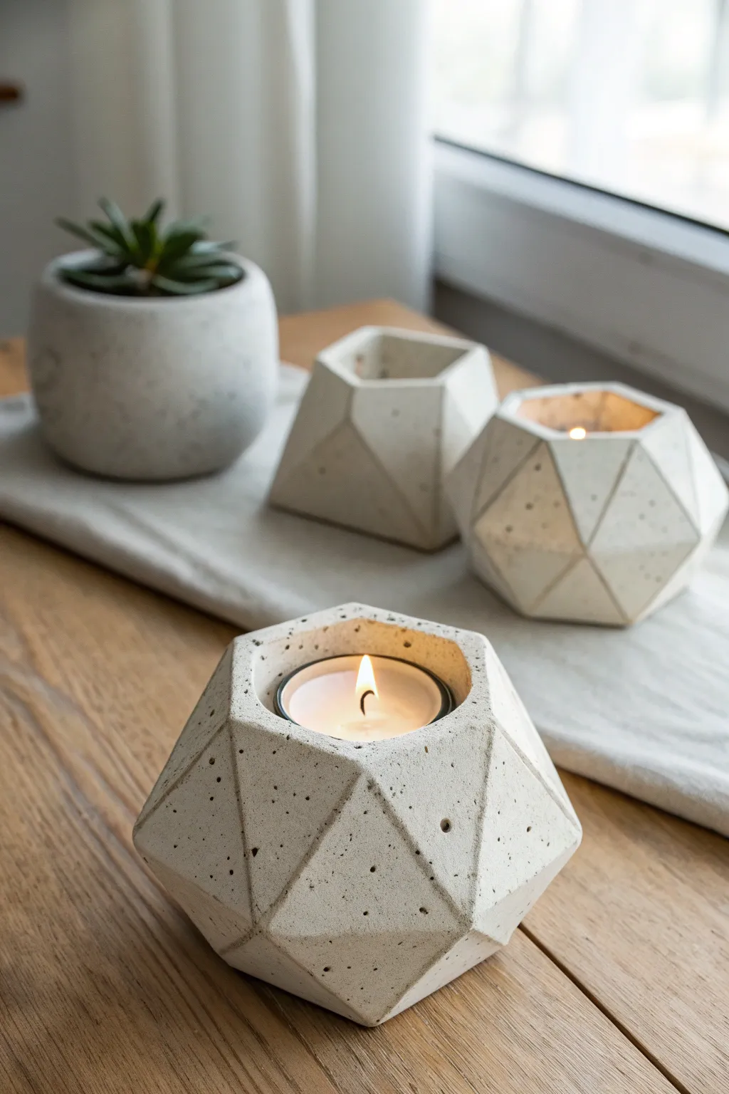 Gem-like faceted clay tea light holder with a soft minimalist glow and subtle boho warmth