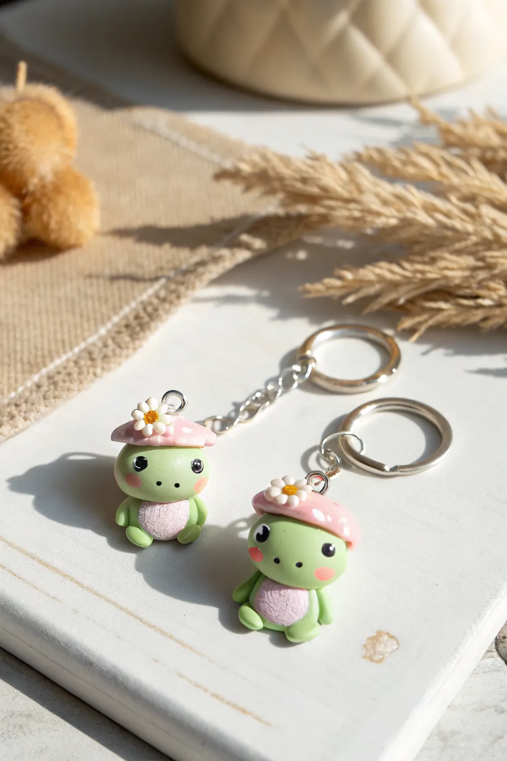 Froggy friends in tiny hats, turned into sweet clay keychain charms for an easy cute DIY look