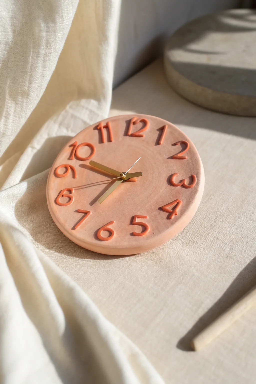 Chunky sculpted clay numerals in bold color make a modern, playful clock for your wall.