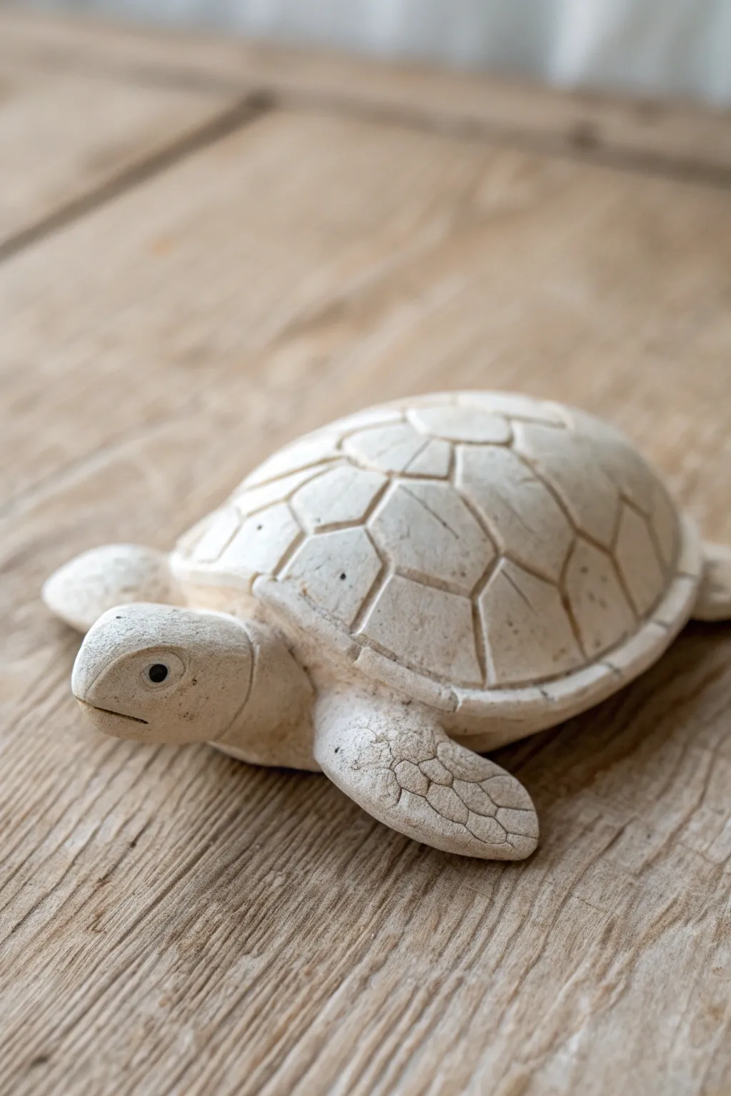 Minimal pinch pot turtle with textured shell lines, softly lit for a calm Scandinavian look