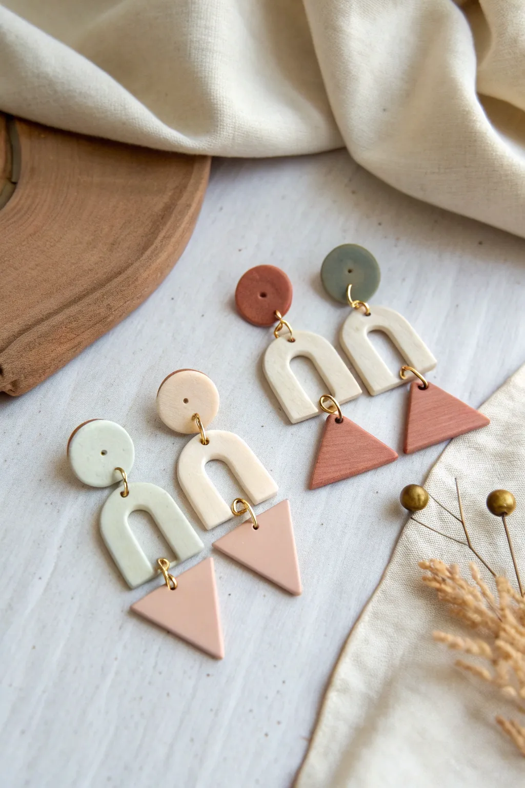 Easy geometric polymer clay earrings in soft neutrals, minimal flat lay for simple DIY inspiration