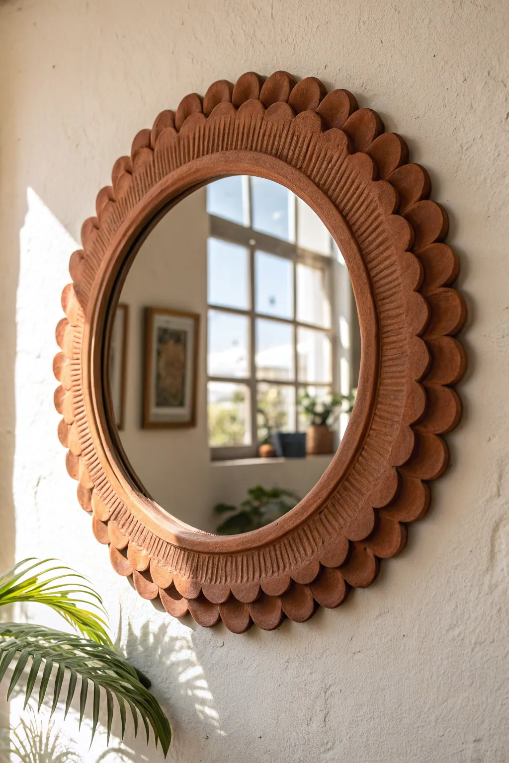 Soft scalloped clay mirror frame in warm daylight, minimalist wall decor with retro charm.