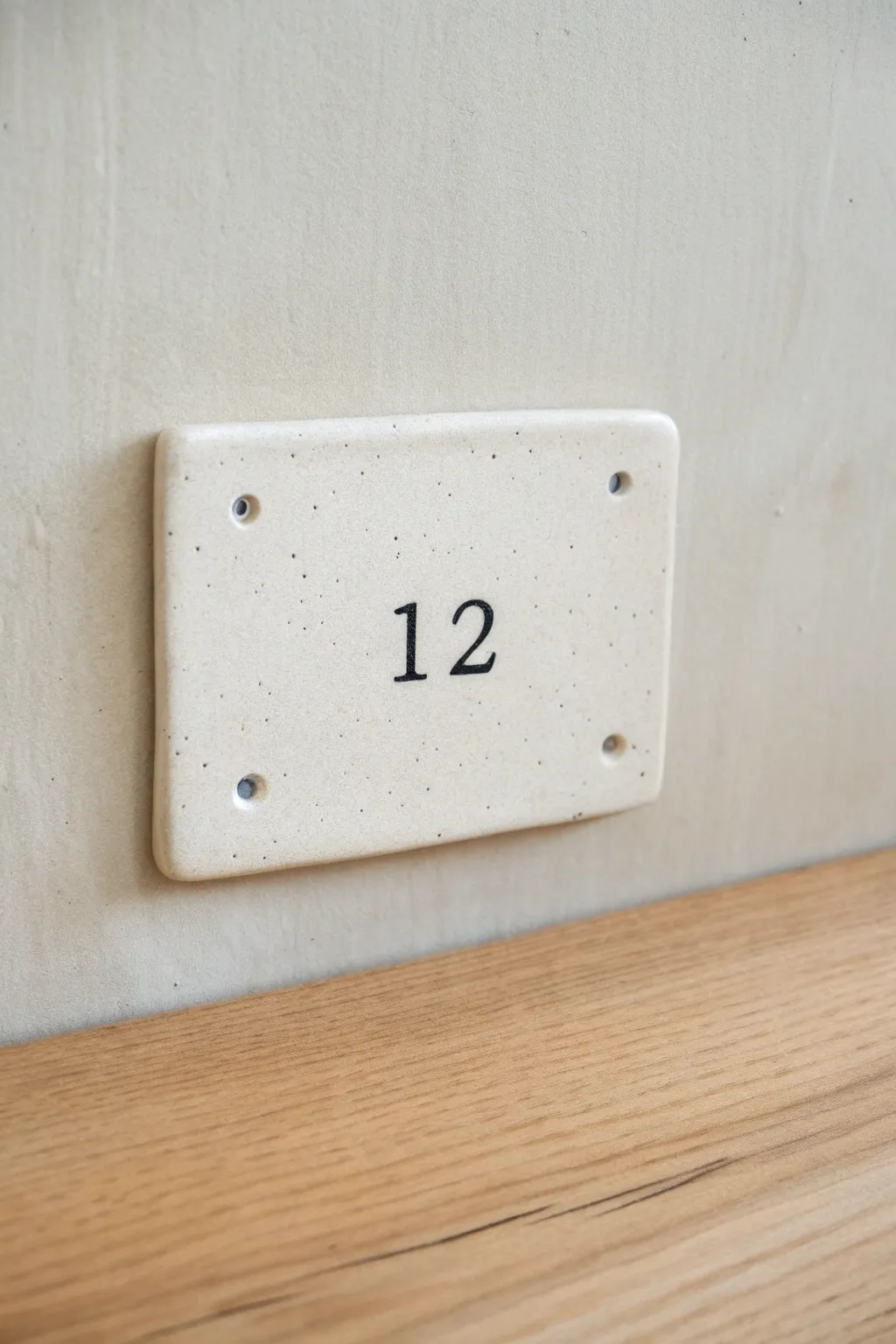 Minimal clay address plaque with raised numbers, high contrast finish, and clean Scandinavian charm.